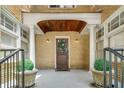 Close-up of front porch with decorative door, wreath, and manicured planters at 653 N Highland Ne Ave # 3, Atlanta, GA 30306
