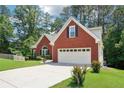 Charming brick home with well-maintained lawn and two car garage with long driveway at 1010 Capella Creek Way, Grayson, GA 30017