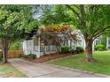 Traditional-style home with a cozy front porch, a well-maintained lawn, and mature trees shading the property at 1634 Glenwood Se Ave, Atlanta, GA 30316