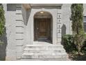 Close-up of the stone staircase and arched doorway leading to the front entrance with the house number at 1712 Shirley Sw St, Atlanta, GA 30310
