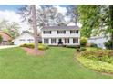 Charming white two-story home featuring lush landscaping, a well-maintained lawn, and a two-car garage at 2730 Burtz Dr, Marietta, GA 30068