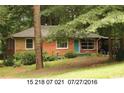 Charming brick home featuring a covered carport and a quaint front door at 3178 Beech Dr, Decatur, GA 30032