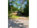 A charming brick home with an attached carport and a well-maintained front yard at 3178 Beech Dr, Decatur, GA 30032