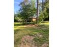 This house has a large front lawn surrounded by mature trees at 3178 Beech Dr, Decatur, GA 30032