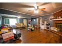 Spacious living room with hardwood floors, a cozy brick fireplace, and plenty of natural light, creating a warm and inviting atmosphere at 8053 Duralee Ln, Douglasville, GA 30134