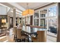 Dining room with large windows, neutral colors, stylish furniture, and modern chandelier at 1125 Lake Shore Overlook, Alpharetta, GA 30005