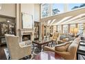 Bright living room featuring a fireplace, high ceilings, and large windows with great natural light at 1125 Lake Shore Overlook, Alpharetta, GA 30005