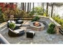 Inviting outdoor patio area with comfortable seating and a cozy stone fire pit at 1125 Lake Shore Overlook, Alpharetta, GA 30005
