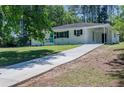A single-story home with a long driveway and a covered porch at 317 Community Sw Dr, Mableton, GA 30126