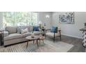 Cozy living room featuring modern furniture, stylish decor, and lots of natural light at 317 Community Sw Dr, Mableton, GA 30126