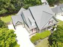 Stunning aerial view of a home with a three-car garage, spacious driveway, and well-maintained landscaping at 330 Bay Grove Rd, Loganville, GA 30052