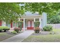 Charming front entrance featuring a red double door, decorative bushes, and a well-manicured lawn at 330 Bay Grove Rd, Loganville, GA 30052