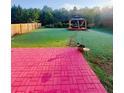 Landscaped backyard features a gazebo and a brick patio at 634 Friars Head Dr, Suwanee, GA 30024