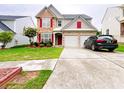 Beautiful home featuring manicured landscaping and a driveway leading to a two-car garage at 634 Friars Head Dr, Suwanee, GA 30024