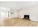 Bright living room featuring wood-look floors and a cozy fireplace at 906 Country Park Se Dr, Smyrna, GA 30080
