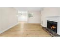 Cozy living room with a fireplace and wood-look flooring at 906 Country Park Se Dr, Smyrna, GA 30080