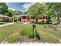Attractive home with a covered carport and a neat front yard featuring a classic mailbox at 243 Woodview Ln, Smyrna, GA 30082