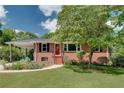 Cozy brick home with a covered carport, neat landscaping, and a welcoming front entrance at 243 Woodview Ln, Smyrna, GA 30082