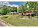 Well-maintained lawn with landscaping leading to the front of the brick house at 243 Woodview Ln, Smyrna, GA 30082