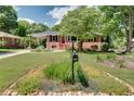 Beautiful brick home with lush lawn and vibrant flowerbeds adding charm to the property at 243 Woodview Ln, Smyrna, GA 30082