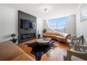 Stylish living room boasts hardwood floors, modern fireplace, comfortable seating, and expansive windows at 2479 Peachtree Ne Rd # 1801, Atlanta, GA 30305