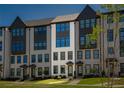 New construction townhomes with light brick, black accents, and green grass at 6790 Encore Blvd, Sandy Springs, GA 30328