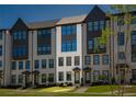 Stylish brick townhome showcases symmetrical design with multiple windows and manicured front lawn at 6790 Encore Blvd, Sandy Springs, GA 30328