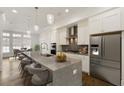Gourmet kitchen boasts stainless appliances, large island, and modern white cabinets at 6790 Encore Blvd, Sandy Springs, GA 30328