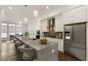 Modern kitchen with stainless steel appliances, a large island, and pendant lighting at 6790 Encore Blvd, Sandy Springs, GA 30328