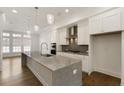 Bright kitchen featuring a large island, sleek countertops, and modern finishes at 6790 Encore Blvd, Sandy Springs, GA 30328