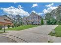 Spacious two-story home featuring a brick and stone exterior, attached garage, and long driveway at 859 Heritage Lake Way, Grayson, GA 30017