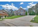Beautiful home with lush lawn, long driveway, and mature landscaping at 859 Heritage Lake Way, Grayson, GA 30017