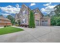 Beautiful house with brick and stone facade, manicured lawn, attached garage and a long driveway at 859 Heritage Lake Way, Grayson, GA 30017