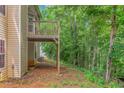 View of a wooden deck overlooking backyard trees and an exterior with vinyl siding at 11354 Conner Ct, Hampton, GA 30228