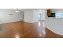 Spacious living room featuring hardwood floors, white walls, and staircase at 11354 Conner Ct, Hampton, GA 30228