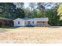 Beautiful single-story home with a charming front porch, set against a backdrop of lush greenery at 1508 Franklin Cir, Dacula, GA 30019