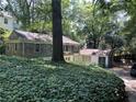 Quaint home with unique architectural design nestled amongst mature trees and lush greenery at 181 Eureka Ne Dr, Atlanta, GA 30305