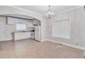 Bright kitchen with white cabinets and tile floors open to dining area at 392 Vine St, Atlanta, GA 30314