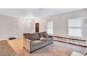 Living room with gray sofa, neutral carpet, and ample natural light at 392 Vine St, Atlanta, GA 30314