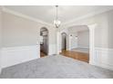 Elegant dining room features decorative molding, archway details, and seamless access to the kitchen at 5034 Hickory Hills Dr, Woodstock, GA 30188