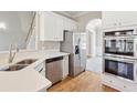 Modern kitchen complete with stainless steel appliances, quartz countertops, and ample cabinet space at 5034 Hickory Hills Dr, Woodstock, GA 30188