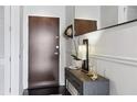 Stylish entryway featuring a modern console table, mirror, and coat rack at 855 Peachtree Ne St # 3005, Atlanta, GA 30308