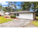 Exterior view of a charming single-story home featuring an attached two-car garage at 1753 Pounds Rd, Stone Mountain, GA 30087