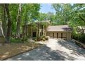 Inviting two-story home with an attached garage, mature trees, and landscaped front yard at 1760 Little Willeo Rd, Marietta, GA 30068
