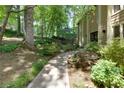 Beautiful walkway leading to the house with mature trees, shrubs, and landscaped yard at 1760 Little Willeo Rd, Marietta, GA 30068