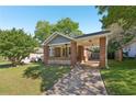 Charming brick home with a covered front porch and a well-maintained lawn at 1841 Thompson Ave, Atlanta, GA 30344