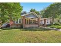 Charming brick home with a covered front porch and a well-maintained lawn at 1841 Thompson Ave, Atlanta, GA 30344