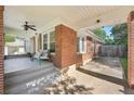 Inviting covered front porch with brick columns and a seating area at 1841 Thompson Ave, Atlanta, GA 30344