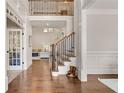 Elegant foyer with hardwood floors, a staircase with iron railings, and wainscoting details at 204 Arthur Hills Dr, Acworth, GA 30101