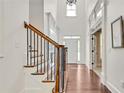 Grand foyer featuring hardwood floors, a staircase with dark iron spindles, and tall ceilings at 204 Arthur Hills Dr, Acworth, GA 30101